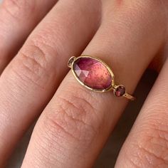 This bicolored Tourmaline goes from deep magenta to peachy pink. We added a pair of Sunset Orange and Peach Sapphires to highlight this stunning color change. Set in 14k yellow gold with a hand hammered gold band. Approximate stone size: 12mm x 8mm Approximate CT weight: 2.75ct Mohs hardness: 7-7.5 This one of a kind piece is handmade with love in Emily's Hudson Valley studio. If you have questions about sizing, shipping or need help deciding on your perfect piece please reach out to us! 14k Gold Pink Gold Jewelry With Gemstone, Handmade 14k Gold Pink Jewelry, Handmade Pink 14k Gold Jewelry, Pink Gold Tourmaline Jewelry With Gemstones, Pink Oval Tourmaline Jewelry, Heirloom Pink Jewelry With Bezel Setting, Pink Oval Bezel Set Jewelry, Pink Oval Jewelry With Bezel Setting, Pink Briolette Ruby Jewelry