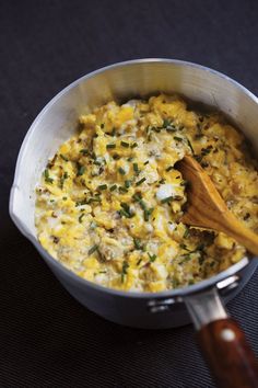 a wooden spoon in a pot filled with food