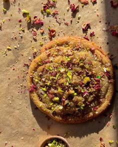 a cake sitting on top of a piece of paper next to a bowl of sprinkles