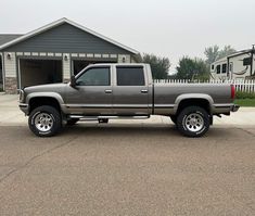 a silver truck parked in front of a house