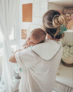 a woman holding a baby in her arms