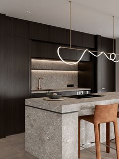 a modern kitchen with marble counter tops and bar stools