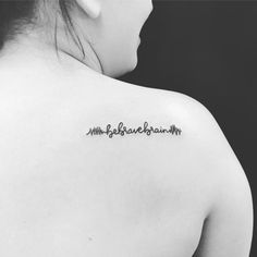 the back of a woman's shoulder with writing on it