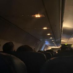 the inside of an airplane with people sitting in it