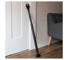 a black floor lamp next to a gray chair