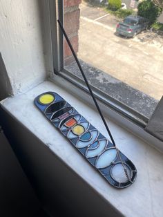 a window sill that has a glass object on it