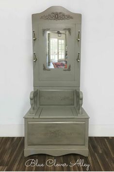 an old dresser with a mirror on top and the bottom drawer open to reveal a bed