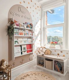 a child's room with a book shelf and toys on the floor next to a window