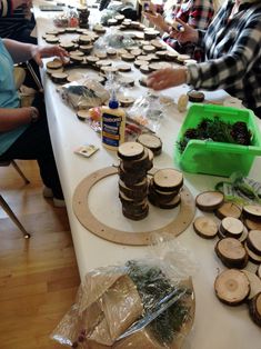 several people sitting at a table covered in wood slices