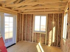 the inside of a house being built with wood framing and insulation on the walls, windows, and doors