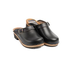 Experience Unmatched Comfort and Style;  Black Wooden Clogs crafted from natural cowhide leather, our 2mm-thick black colored clogs redefine comfort and elegance. The addition of an adjustable strap with a buckle ensures a snug fit, eliminating worries about fastening length. Glide through your day with ease, knowing these wooden shoes provide the perfect balance of support and flexibility. Premium Material, Superior Quality;  Step into luxury with our closed toe wooden clogs, meticulously designed for both clogs men and clogs women. The durable upper crafted from natural cowhide leather promises longevity, while the real wood and PU rubber bottom offer stability without the traditional clacking sound. Elevate your footwear collection with these premium, versatile clogs. Unleash Your Style High Heel Clogs, Swedish Clogs, Clogs And Mules, Wooden Clogs, Clog Heels, Alder Wood, Wooden Shoes, Slingback Shoes, Leather Clogs