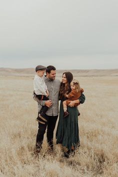 a family standing in the middle of a field