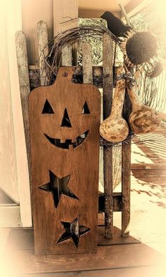 a wooden sign that says happy fall with pumpkins and jack - o'- lanterns