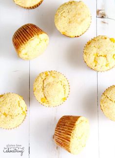 several muffins sitting on top of a white table next to a cupcake