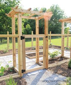 an outdoor garden with wooden posts and fencing