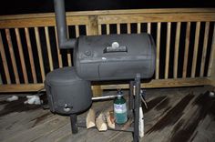 an outdoor bbq grill on a deck