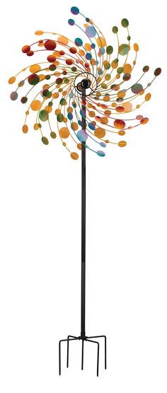 a metal sculpture with multicolored circles on it's top and bottom stand