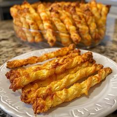 some fried food is on a white plate and next to another plate with other food items