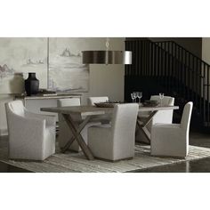 a dining room table with white chairs around it