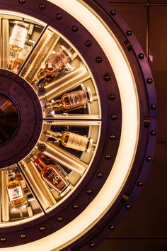 the inside of a circular display case with liquor bottles in it's centerpiece