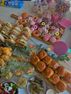 a table topped with lots of different types of foods and desserts next to each other