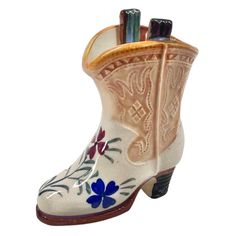 You Are Looking To Buy: Vintage 1940's Occupied Japan Porcelain COWBOY BOOT 4" Mini Vase Western Decor -Excellent Condition! • Size: 4" High • Color: Cream Multicolor Details: • Porcelain • Marked On Bottom: "Made In Occupied Japan" • Western Ceramic Boots with floral design • It has block heel design • It is a pretty unique because it is so beautiful as you can see it in the pictures. • This is a vintage 1940's occupied Japan piece in perfect shape. It is hand painted, has a tulip floral design on the toe and trimmed in an ocher brown around the base and on the upper raised sculpture of the boot. So very cute perfect for the cow girl, rodeo person, horse lover in your life, Excellent Condition! Great Gift for Him or Her - or For Yourself! Buy In Confidence From 100% Positive Feedback Sell Cowboy Boot Ornaments, Cowboy Boot Pottery, Pottery Projects, Mini Vase, The Cow, Heel Design, Cow Girl, Cowboy Boot, Western Decor