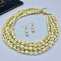 Elevate your style with our Elegant Ivory White Multi Strand Necklace. This chunky beaded statement piece is handcrafted with multiple layers of smooth ivory beads, offering a sophisticated touch to any outfit. Perfect as a thoughtful gift for her, this necklace is designed to impress, making it an exquisite addition to any woman's jewelry collection. This is a handcrafted necklace, uniquely designed with attention to every detail. - Necklace length is 17.5" long, 7 STRANDS plus additional 4 inc Luxury Handmade Long Necklace For Gift, Luxury White Multi-strand Necklace, Luxury White Beaded Statement Necklaces, Luxury White Artisan Necklace, Luxury Multi-strand Jewelry Statement Piece, Luxury White Artisan Beaded Necklaces, Luxury White Multi-strand Beaded Necklaces, Luxury Statement Multi-strand Beaded Necklace, Luxury Long White Beaded Necklaces