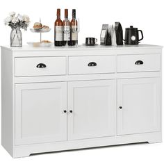 a white cabinet with bottles and glasses on top