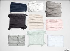 six different colors of cloths laid out on a white surface with one folded in the middle