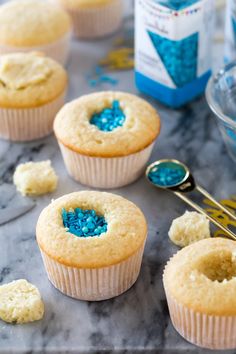 some cupcakes with blue sprinkles on them