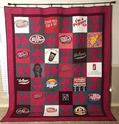 a red and black quilt with various stickers on it