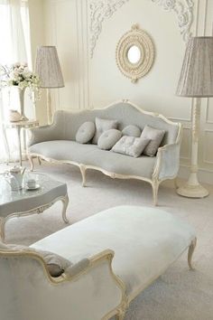 a white living room with couches and lamps