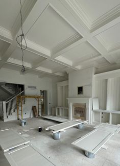 an unfinished room with white walls and floors