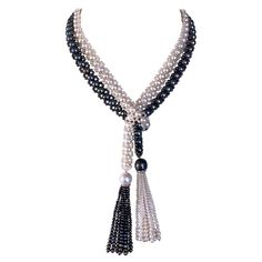 Classic Sautoir by Marina J. This stunning 'Art Deco' inspired piece is made of all cultured Black & White Pearls woven together into a lace like column. The White Pearls display a wonderful luster and the Black Pearls radiate an almost 'oil spill' like iridescence to them. Measuring 45.5 inches long sans Tassels, this each end of this Sautoir meets at a 3.5 inch Tassel. The Tassels feature gorgeous Baroque Pearls sitting atop a solid 14k White Gold - Diamond encrusted roundel, from which graduated strands of Pearls hang. This Sautoir's length allows it to be worn in multiple fashion as shown in photos, and is a perfect statement piece for any occasion. ** Made by Marina J. ** ** For any questions or inquiries please direct message or email me ** Black Pearls, J Black, Oil Spill, Art Deco Inspired, Black Pearl, Baroque Pearls, White Gold Diamonds, Pearl White, Tassel Necklace