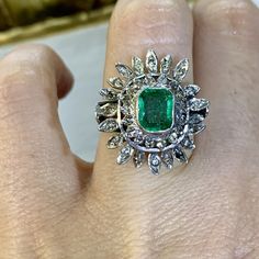 Metal: Silver And 9 Karat White Gold. The shank is silver and the top part of the ring is 9kt gold. Stones: Emerald And Diamond Shape: Round and Emerald-cut Approximate Emerald Weight: 1.50 ctw Approximate Measurements Of Emerald: 8.00 x 6.00mm Approximate Diamond Weight: .70 ctw Ring Size: 7 Sizable: No Weight of entire piece with stones: 6.10 grams Measurements Of Center Part Of Ring: 22.00mm And  Long  21.00mm wide Width Of Shoulders: 5.00mm Height Of Ring From Top To Bottom: 30.00mm Age: Vintage, approximately 1950's. Link For Matching Necklace: https://bfjewelryest1984.etsy.com/listing/1664423302/vintage-emerald-and-diamond-ballerina Ballerina Style, Center Part, Emerald Gem, Stunning Earrings, Matching Necklaces, Diamond Shape, Delicate Necklace, Star Necklace, Ring Size 7