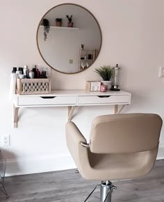 a chair and mirror in a room with a hair dryer on the table next to it