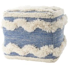 a blue and white poufle with fringes on the bottom is sitting in front of a white background