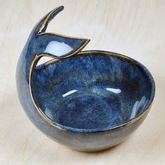 a blue and white bowl sitting on top of a wooden table