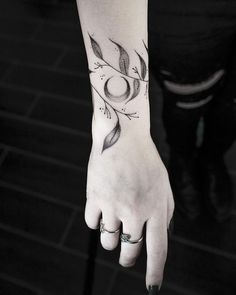 a woman's hand with a tattoo on it and an arrow in the middle