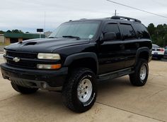 a black truck parked in a parking lot