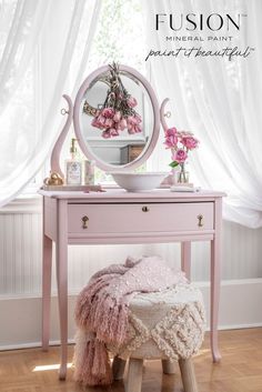 a pink vanity table with flowers on it and a mirror over the top that says, fuson mineral paint beautiful