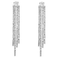 These wonderful pair of chandelier long drop earrings are designed in lustrous 18K white gold studded with baguette and round brilliant cut diamonds. These earrings are studded with a total of 196 diamonds. Total diamond weight: 2.65 carats. Diamond color G-H and clarity VS-SI. Impressive long tassels dangle earrings that dance with every step that you make. Secured with pushback posts. Earring length: 2.5 inches. Total weight: 11.74 grams. Comes with a presentable gift box. Chandelier Long, Modern Hoop Earrings, Diamond Chandelier Earrings, Diamond Chandelier, Round Diamond Earrings, Large Stud Earrings, White Gold Studs, Long Drop Earrings, Diamond Drops