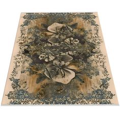 an area rug with flowers and leaves on the bottom, in beiges and blues