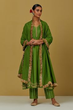 Green kurta with floral embroidery and V neck. Paired with sequin work pant and tissue organza fringe dupatta.
Components:3
Pattern:Embroidered
Type of Work:Floral
Neckline:V Neck
Sleeve Type:Flared
Fabric:Chanderi Silk, Tissue Organza
Color:Green
Other Details:
Floral and sequin work
Occasion:Puja - Aza Fashions High-end Chanderi Unstitched Suit With Sheer Dupatta, Luxury Chanderi Churidar With Cutdana, Luxury Chanderi Palazzo Set With Embroidered Border, Luxury Chanderi Kurta For Party Wear, Luxury Chanderi Kurta For Festival, Luxury Chanderi Pant Set For Diwali, Luxury Chanderi Sets With Self Design, Luxury Chanderi Pant Set With Dupatta, Luxury Chanderi Designer Sets