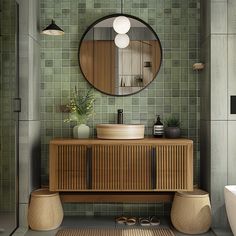 a bathroom with green tiles and a round mirror