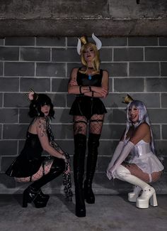 three women dressed in costumes posing for the camera