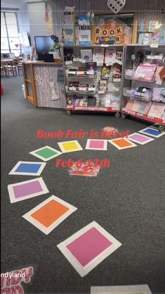 the floor in a store has been decorated with different colored squares and numbers on it