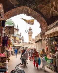 people are walking through an open market area