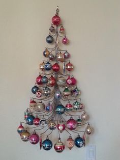 a christmas tree made out of ornaments hanging on the wall