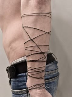 a man's arm is wrapped in black string